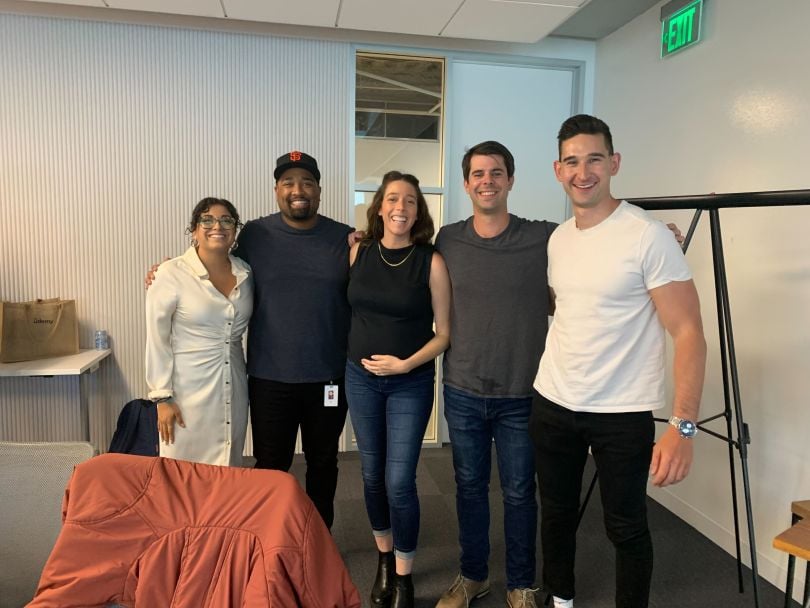 Udemy team members standing together in an office